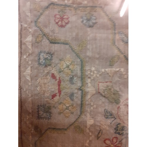 64 - A 1770 fine needlepoint on muslin sampler depicting religious verse from Exodus flanked by a male an... 