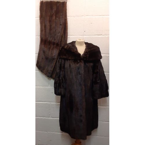 59 - A dark brown glossy mink coat with shawl collar and flared sleeves having 2 side pockets, approx 44