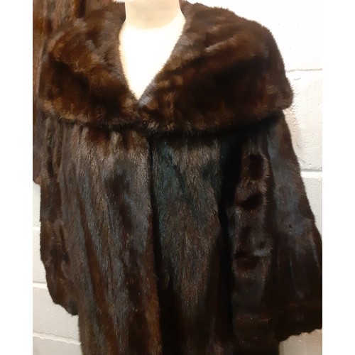 59 - A dark brown glossy mink coat with shawl collar and flared sleeves having 2 side pockets, approx 44