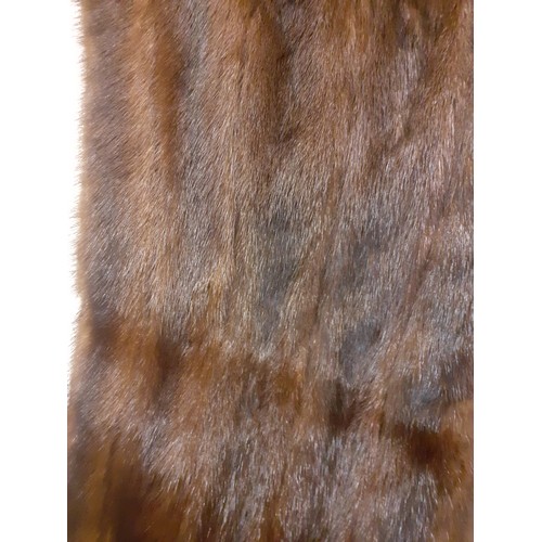 59 - A dark brown glossy mink coat with shawl collar and flared sleeves having 2 side pockets, approx 44