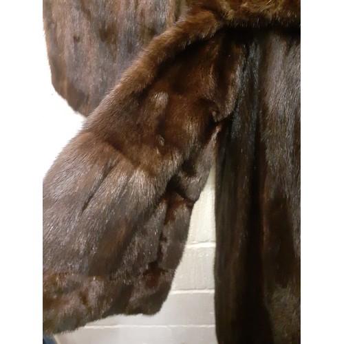 59 - A dark brown glossy mink coat with shawl collar and flared sleeves having 2 side pockets, approx 44