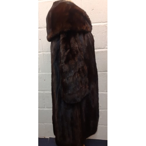 59 - A dark brown glossy mink coat with shawl collar and flared sleeves having 2 side pockets, approx 44