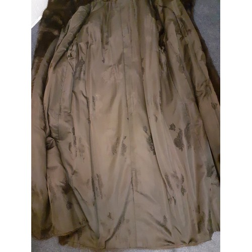 59 - A dark brown glossy mink coat with shawl collar and flared sleeves having 2 side pockets, approx 44