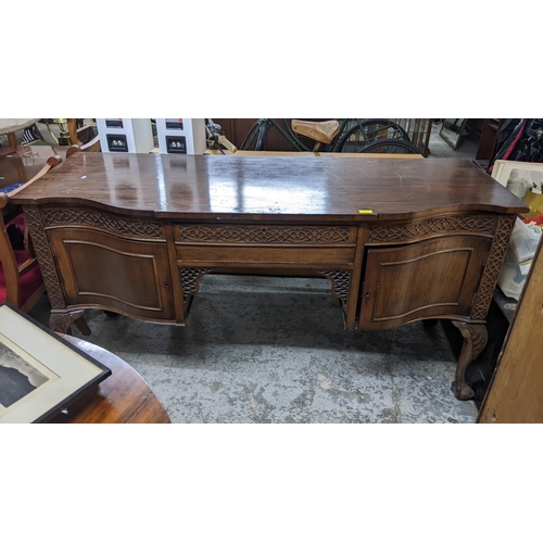 550 - A mixed lot of furniture to include a 1920s serpentine fronted sideboard, single drawer over two cup... 