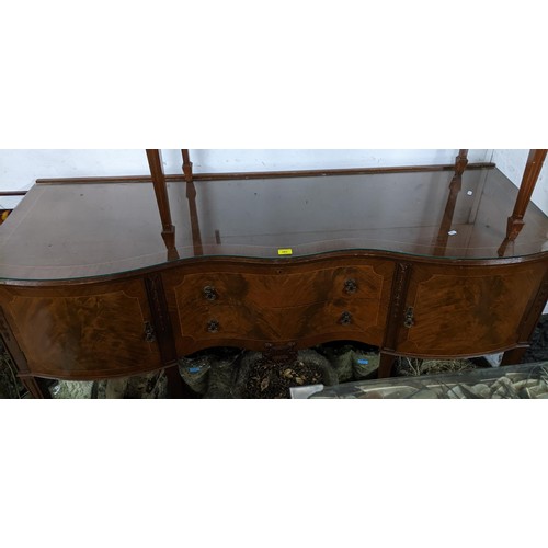 550 - A mixed lot of furniture to include a 1920s serpentine fronted sideboard, single drawer over two cup... 