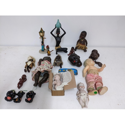 593 - A collection of vintage dolls and other items to include a Western German ceramic figurines of an Af... 