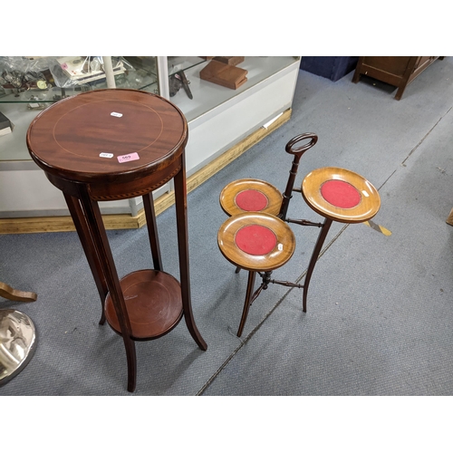 569 - An Edwardian inlaid mahogany torcher and a mahogany three tier cake stand
Location:A4B
If there is n... 