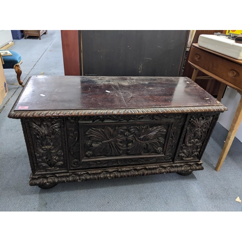 580 - A late 19th century carved oak chest with a hinged top on ball feet
Location:LWB
If there is no cond... 