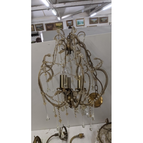 553 - A selection of brass and gilt coloured light fittings to include a pair of three waterfall chandelie... 