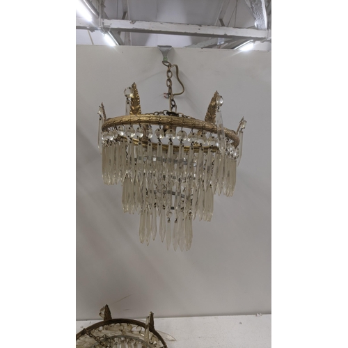 553 - A selection of brass and gilt coloured light fittings to include a pair of three waterfall chandelie... 