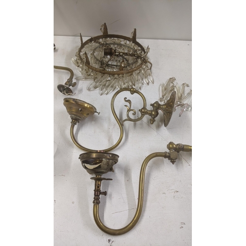 553 - A selection of brass and gilt coloured light fittings to include a pair of three waterfall chandelie... 