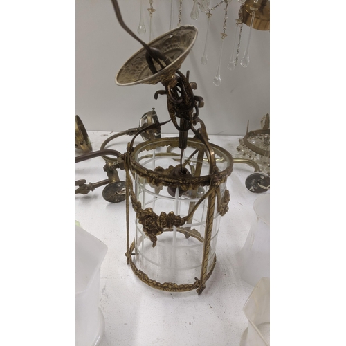 553 - A selection of brass and gilt coloured light fittings to include a pair of three waterfall chandelie... 