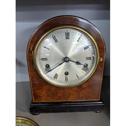 576 - Two early 20th century mantle clocks with domed tops, one faced with a Roman dial, the other with an... 