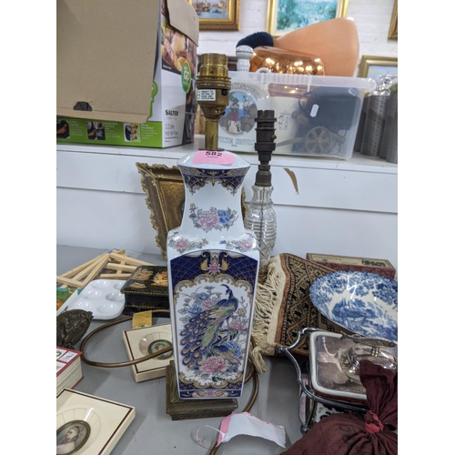 582 - A mixed lot to include two candlesticks, a Chinese style table lamp, a decorative box and games to i... 