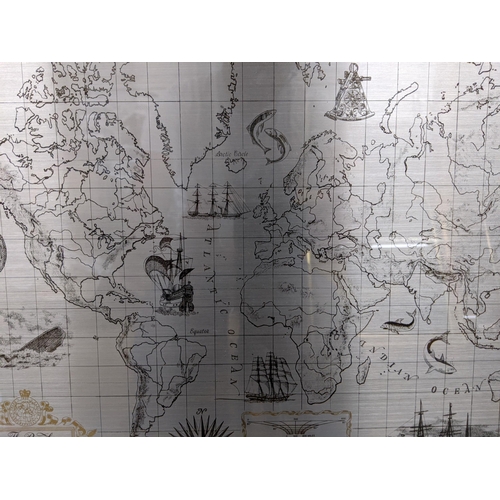 584 - A limited edition Royal Geographical Society silver map decorated with gold repeating design around ... 