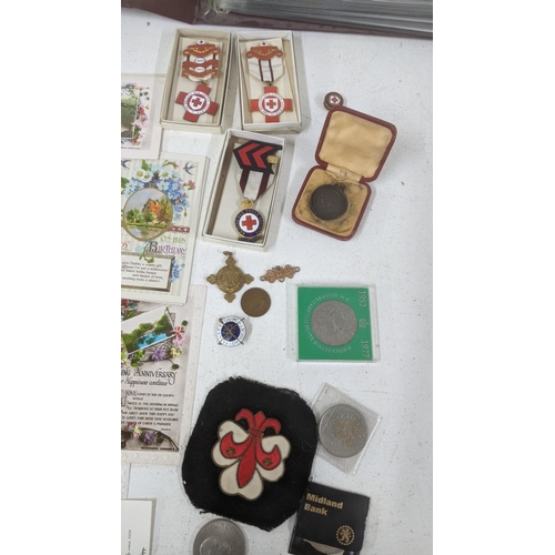 589 - A mixed lot to include medals and cap badges and coins to include Royal army medical corps badge and... 