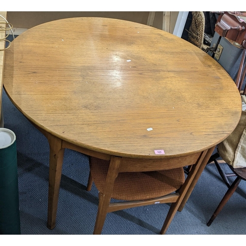 520 - A mid 20th century Nathan teak circular extending dining table, 76h x 122w, un-extended, together wi... 