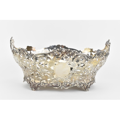 10 - A Victorian silver fruit basket, by Daniel & John Wellby, hallmarked London 1897, having a pierced f... 