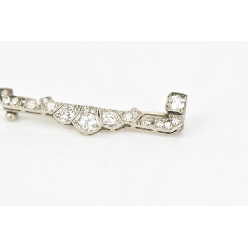 100 - Two brooches to include an Art Deco platinum diamond bar brooch set with sixteen diamonds, largest a... 