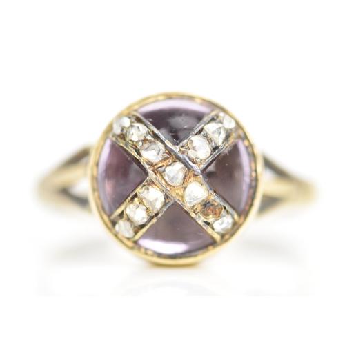 104 - A Victorian 18ct gold ring, set with a circular amethyst cabochon with diamonds overlapping in a cro... 