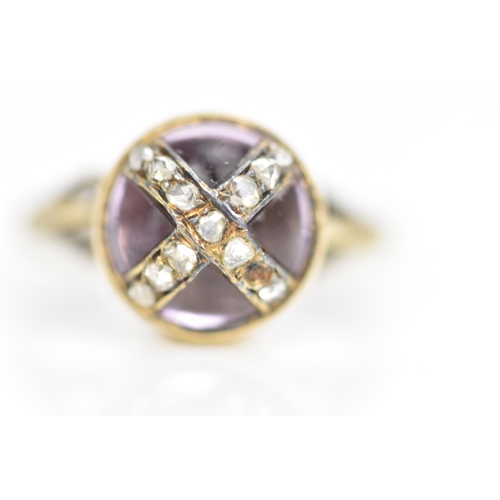 104 - A Victorian 18ct gold ring, set with a circular amethyst cabochon with diamonds overlapping in a cro... 