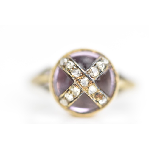 104 - A Victorian 18ct gold ring, set with a circular amethyst cabochon with diamonds overlapping in a cro... 