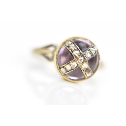 104 - A Victorian 18ct gold ring, set with a circular amethyst cabochon with diamonds overlapping in a cro... 