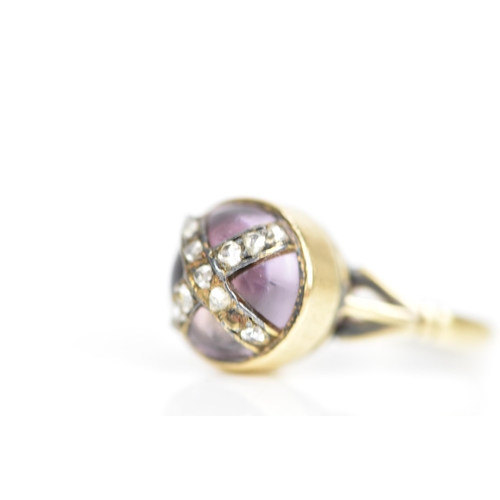 104 - A Victorian 18ct gold ring, set with a circular amethyst cabochon with diamonds overlapping in a cro... 