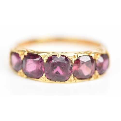 105 - A Victorian yellow gold ring set with five faceted cut amethysts graduating in size, the largest app... 