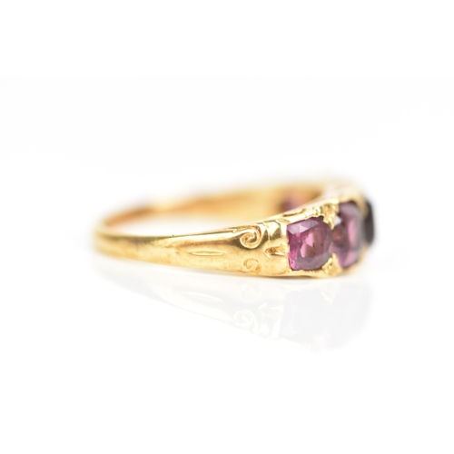 105 - A Victorian yellow gold ring set with five faceted cut amethysts graduating in size, the largest app... 