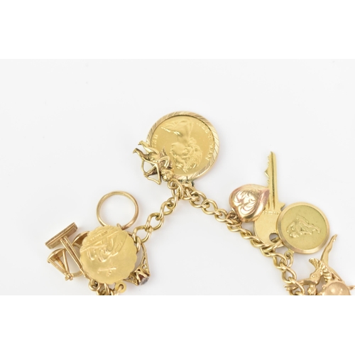 108 - A 9ct yellow gold curb link charm bracelet, with various 9ct gold charms including a thimble, teapot... 