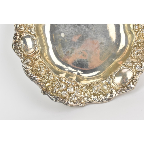 11 - A Swedish 1930s silver dish, hallmarked 1933, the shaped border heavily embossed with C-scrolls, thr... 