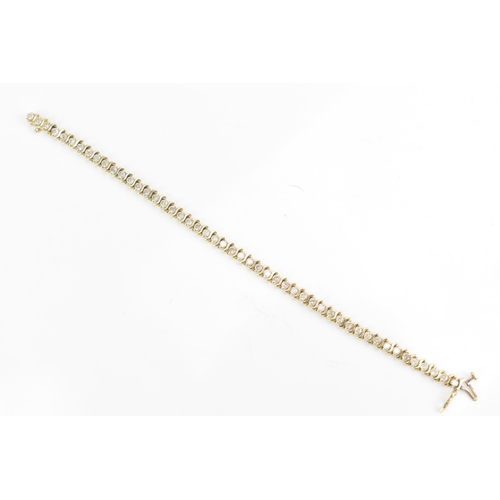 110 - A 14ct gold diamond tennis bracelet, with forty-six diamonds in claw settings, stamped 14K, each sto... 