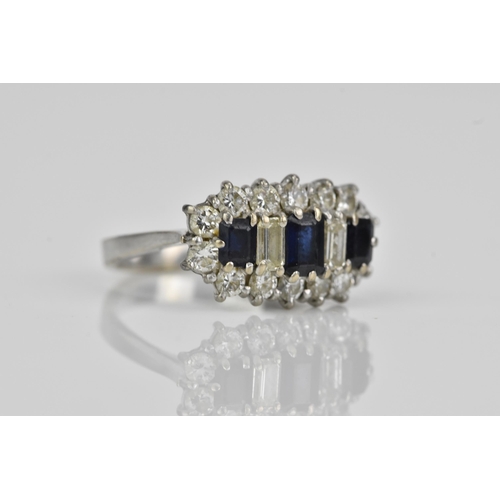 114 - An 18ct white gold sapphire and diamond dress ring, having three baguette cut sapphires and two bagu... 