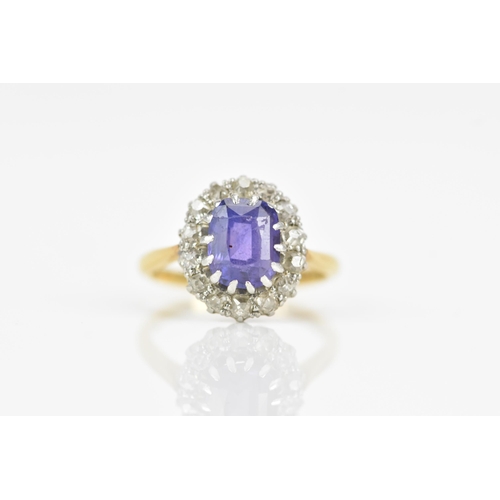 116 - An 18ct gold amethyst and diamond cluster ring, the central amethyst 7.9mm x 6.4mm, surrounded by a ... 