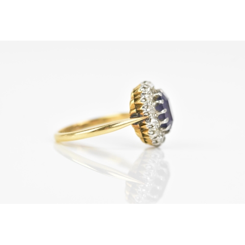 116 - An 18ct gold amethyst and diamond cluster ring, the central amethyst 7.9mm x 6.4mm, surrounded by a ... 