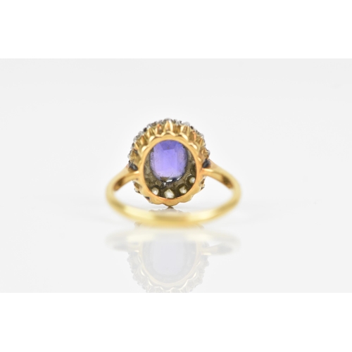 116 - An 18ct gold amethyst and diamond cluster ring, the central amethyst 7.9mm x 6.4mm, surrounded by a ... 