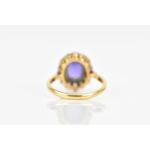 116 - An 18ct gold amethyst and diamond cluster ring, the central amethyst 7.9mm x 6.4mm, surrounded by a ... 