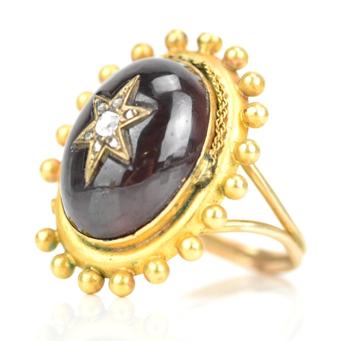 119 - A Victorian yellow gold garnet and diamond cabochon ring, the oval cabochon 19mm x 14.3mm, star set ... 