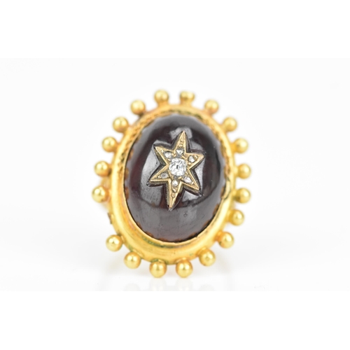 119 - A Victorian yellow gold garnet and diamond cabochon ring, the oval cabochon 19mm x 14.3mm, star set ... 