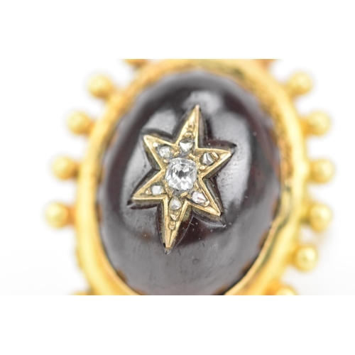 119 - A Victorian yellow gold garnet and diamond cabochon ring, the oval cabochon 19mm x 14.3mm, star set ... 