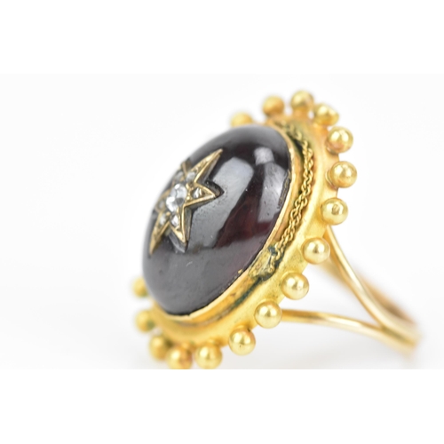 119 - A Victorian yellow gold garnet and diamond cabochon ring, the oval cabochon 19mm x 14.3mm, star set ... 