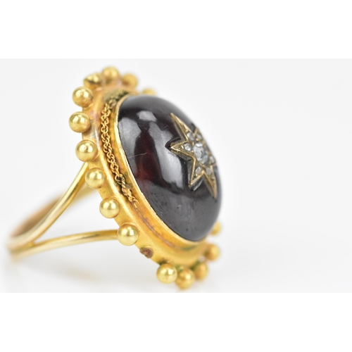 119 - A Victorian yellow gold garnet and diamond cabochon ring, the oval cabochon 19mm x 14.3mm, star set ... 