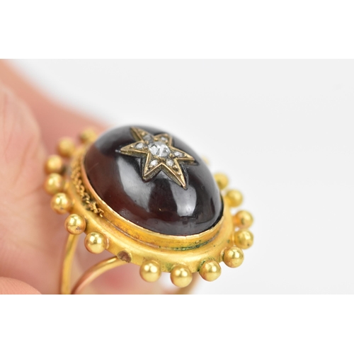 119 - A Victorian yellow gold garnet and diamond cabochon ring, the oval cabochon 19mm x 14.3mm, star set ... 