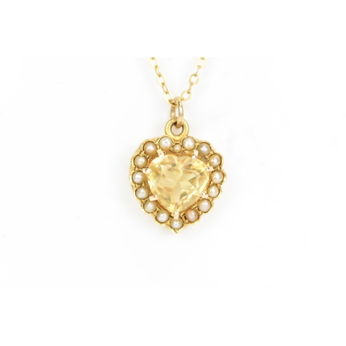 123 - A 15ct yellow gold citrine and seed pearl pendant with a yellow gold chain, the heart shaped pendant... 