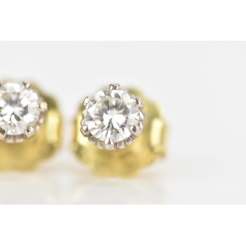 125 - A pair of 18ct yellow and white gold diamond earrings, each brilliant cut diamond 4.7mm, approx colo... 