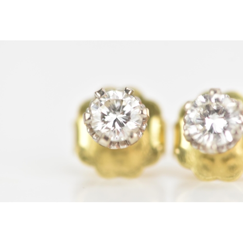 125 - A pair of 18ct yellow and white gold diamond earrings, each brilliant cut diamond 4.7mm, approx colo... 