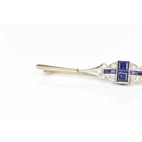 134 - An Art Deco 18ct white gold and platinum bar brooch, set with two central sapphires 3.4mm x 3mm, fla... 