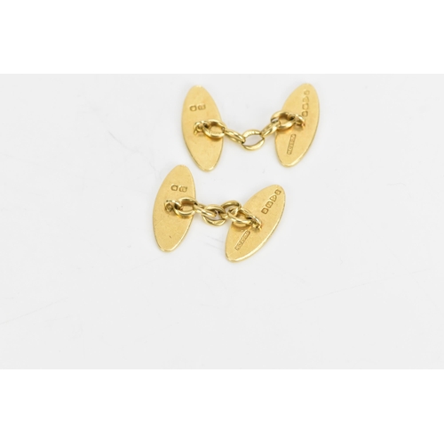 139 - A pair of 18ct yellow gold cufflinks, each of oval form with chain links and engraved with a monogra... 