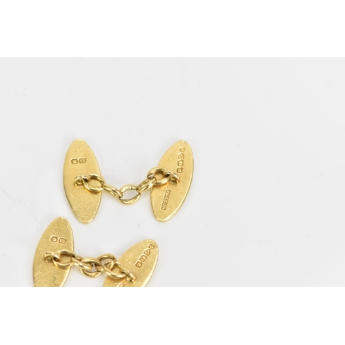 139 - A pair of 18ct yellow gold cufflinks, each of oval form with chain links and engraved with a monogra... 